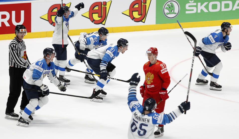 Russia's Nikita Gusev skates past Players of Finland celebrating after the Ice Hockey World Championships semifinal match between Russia and Finland at the Ondrej Nepela Arena in Bratislava, Slovakia, Saturday, May 25, 2019. (AP Photo/Petr David Josek)