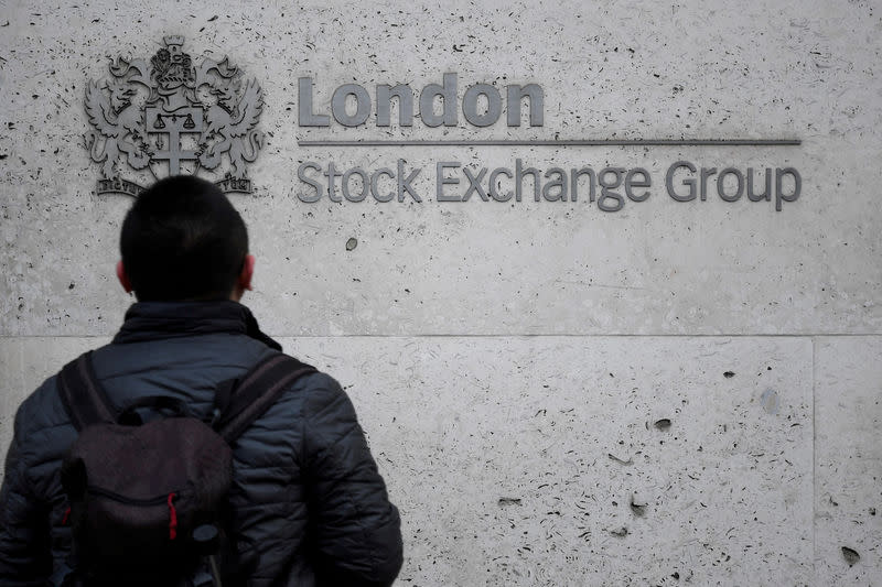 FILE PHOTO: People walk past the London Stock Exchange Group offices in the City of London, Britain, December 29, 2017. REUTERS/Toby Melville/File Photo