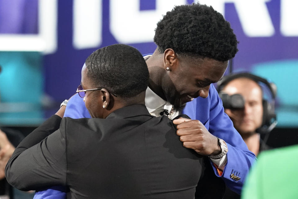 Mark Williams, right, is congratulated by family and friends after being selected the Charlotte Hornets in the NBA basketball draft, Thursday, June 23, 2022, in New York. (AP Photo/John Minchillo)