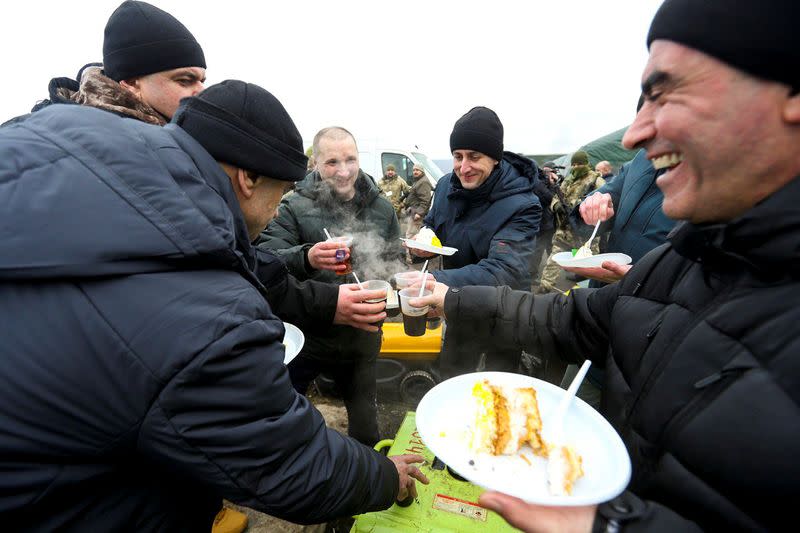Ukrainian citizens have meals after the exchange of prisoners of war between Ukraine and the separatist republics near the Mayorsk crossing point in Donetsk region