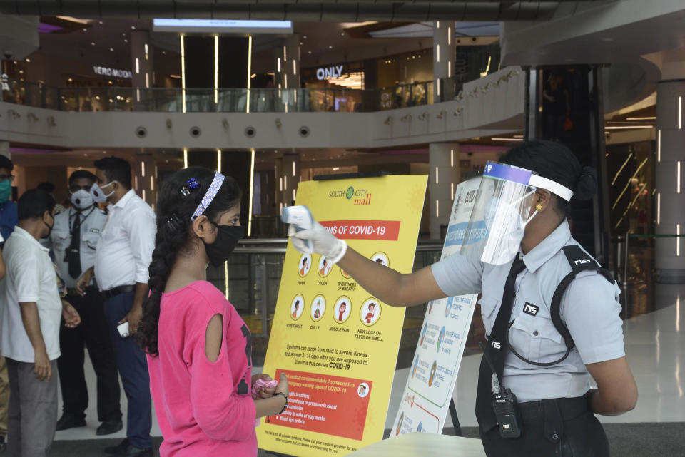 KOLKATA, INDIA - JUNE 8: A security guard thermal screening people at South City Mall as it opens to the public after lockdown relaxations, on June 8, 2020 in Kolkata, India. (Photo by Samir Jana/Hindustan Times via Getty Images)