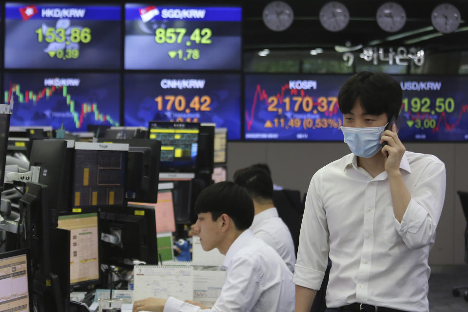 A currency trader talks on the mobile phone at the foreign exchange dealing room of the KEB Hana Bank headquarters in Seoul, South Korea, Thursday, July 9, 2020. Asian stock markets followed Wall Street higher on Thursday following gains for major U.S. tech stocks. (AP Photo/Ahn Young-joon)