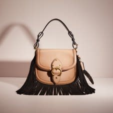 A taupe fringed Coach bag as part of (Re)Loved