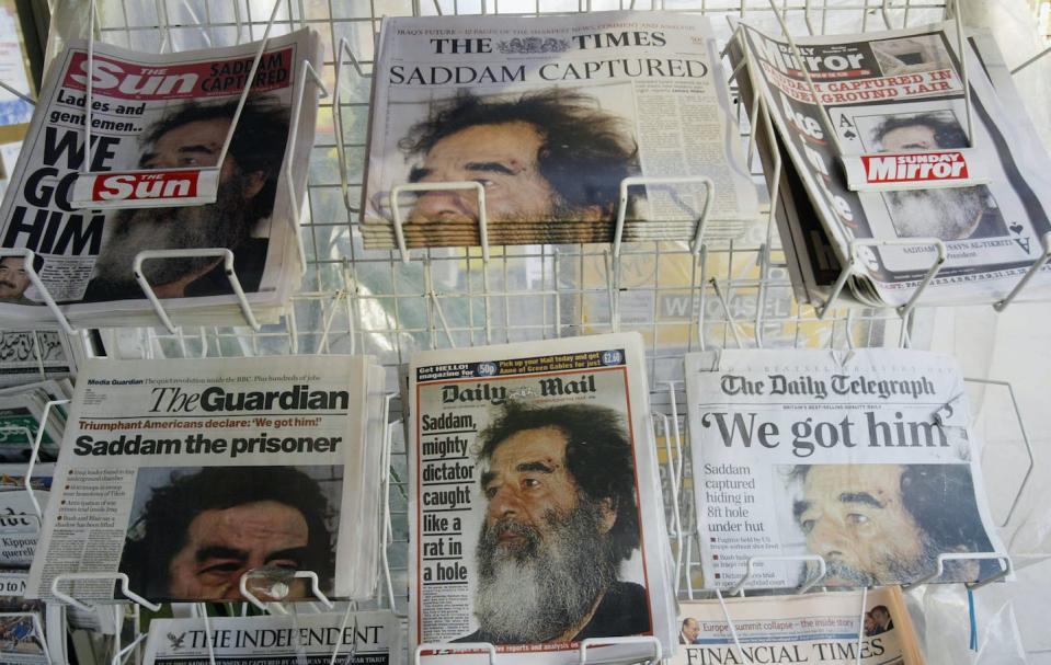 A newsstand sells papers reporting the capture of Saddam Hussein, former leader of Iraq, by U.S. forces in 2003. <a href="https://media.gettyimages.com/id/2811512/photo/papers-run-story-on-saddam-capture.jpg?s=1024x1024&w=gi&k=20&c=1H9qDW1rPW1wVPbyKH3HUrgRll8pRZ36ZhzVeS-rM6A=" rel="nofollow noopener" target="_blank" data-ylk="slk:Graeme Robertson/Getty Images;elm:context_link;itc:0;sec:content-canvas" class="link ">Graeme Robertson/Getty Images</a>