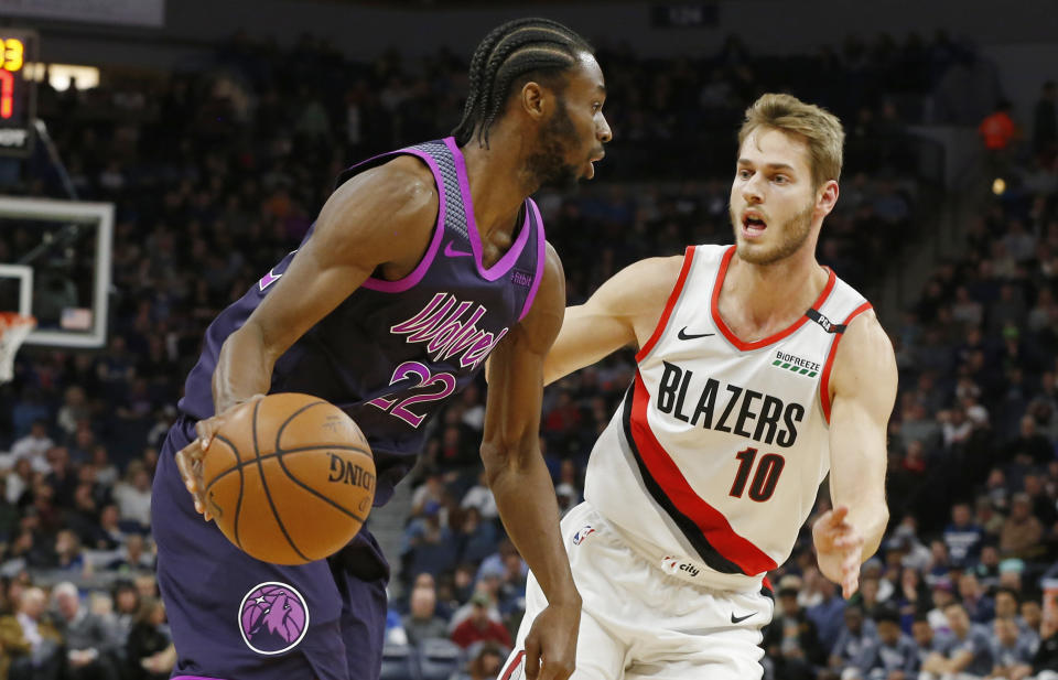 Minnesota Timberwolves' Andrew Wiggins, left, drives around Portland Trail Blazers' Jake Layman during the second half of an NBA basketball game Friday, Nov. 16, 2018, in Minneapolis. The Timberwolves won 112-96. (AP Photo/Jim Mone)