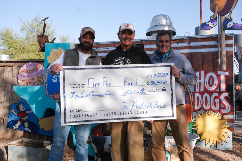 Danny (left) and Bobby Lee stand with Amarillo Mayor Cole Stanley with the check for the funds raised Sunday at the Panhandle Boys: West Texas Relief Concert at the Starlight Ranch in Amarillo.