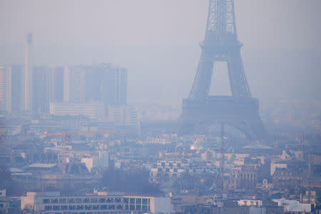 The Eiffel Tower is surrounded by a small-particle haze which hangs above the skyline in Paris, France, December 9, 2016 as the City of Light experienced the worst air pollution in a decade. REUTERS/Gonzalo Fuentes/Files