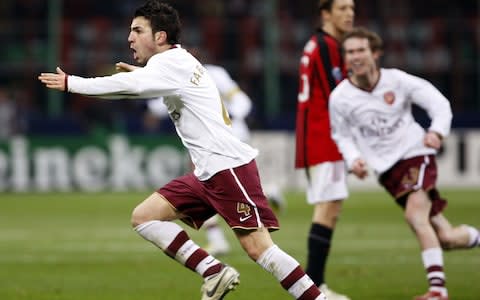 Arsenal's Spanish player Cesc Fabregas (L) reacts to scoring the opening goal against A.C. Milan during the UEFA Champions League quarter-final match at San Siro Stadium in Milan on March 4, 2008 - Credit: AFP