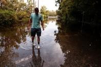 Tristan Rice checks to see how many inches of water occurred at Hood Landing boat ramp before Hurricane Dorian in Jacksonville, Florida