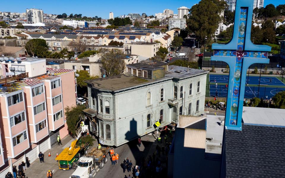 A truck pulls a Victorian home through San Francisco on Sunday, Feb. 21, 2021.