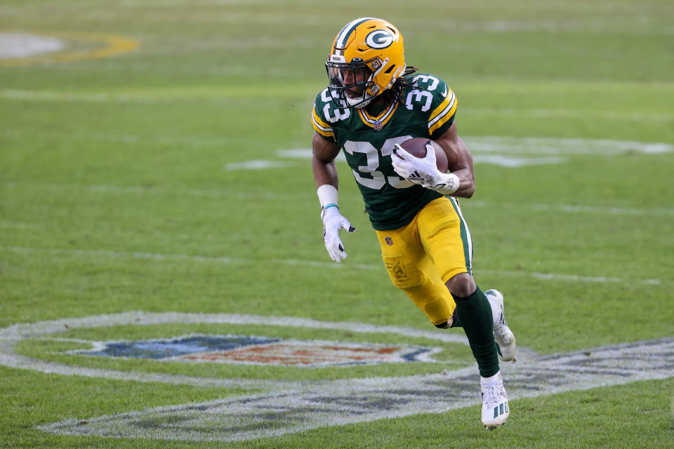 GREEN BAY, WISCONSIN - JANUARY 24: Aaron Jones #33 of the Green Bay Packers runs with the ball in the second quarter against the Tampa Bay Buccaneers during the NFC Championship game at Lambeau Field on January 24, 2021 in Green Bay, Wisconsin. (Photo by Dylan Buell/Getty Images)