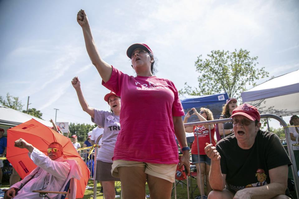 From left, Maureen Fuster, Rosealinda Dorris and Carole Greenberg chant "Trump" while waiting in line to see President Donald Trump, Wednesday morning, July 17, 2019 prior to a campaign rally at East Carolina University in Greenville, NC.(Travis Long/The News & Observer via AP)