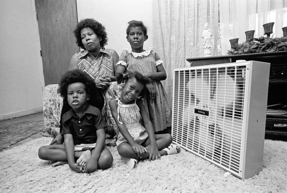 July 29, 1980: Vera Darnell, daughter Fatima, 12, and grandchildren Shannon, 3, and Alisha, 4, in their living room with a fan, getting relief from the heat. The window fan was given to the family by a volunteer from the Tarrant County United Way. Vince Heptig/Fort Worth Star-Telegram archive/UT Arlington Special Collections