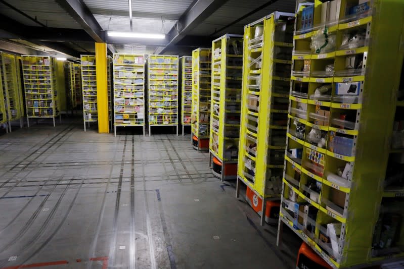 Tracks are left on the floor showing where robots carry shelves full of items inside of an Amazon fulfillment center on Cyber Monday in Robbinsville, New Jersey