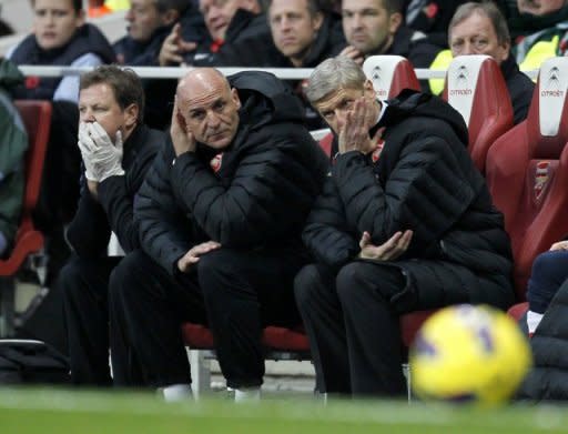 Arsenal manager Arsene Wenger, far right, watches in frustration as his side allowed a two-goal lead to slip for the second time in five days before eventually being forced to settle for a point in a 3-3 home draw with Fulham