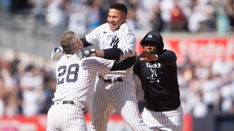 Gleyber Torres celebrating with Josh Donaldson and Luis Severino following walk-off hit