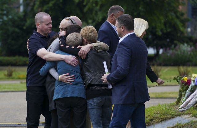 Family members of Dr David Wails, after laying a single yellow rose each at the bandstand in Forbury Gardens in Reading, during a memorial service to mark the one year anniversary of the terror attack.