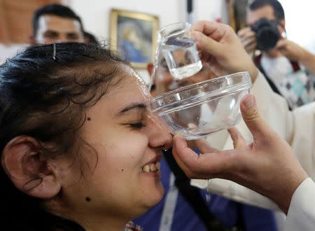 Roma pilgrim is christened in the chapel in Csatka, Hungary on September 9, 2017. REUTERS/Laszlo Balogh