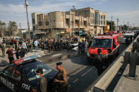 Iraqi security forces inspect the site of an explosion in Basra, Iraq, Tuesday, Dec. 7, 2021. The explosion rocked the center of Iraq’s southern city of Basra, killing at least four people and wounding several others. Local news reports initially reported a car bomb, but the governor of Basra told reporters on the scene that a motorcycle had exploded. (AP Photo/Nabil al-Jurani)