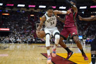 Milwaukee Bucks forward Giannis Antetokounmpo (34) drives to the basket as Miami Heat forward Markieff Morris defends during the first half of an NBA basketball game Thursday, Oct. 21, 2021, in Miami. (AP Photo/Lynne Sladky)