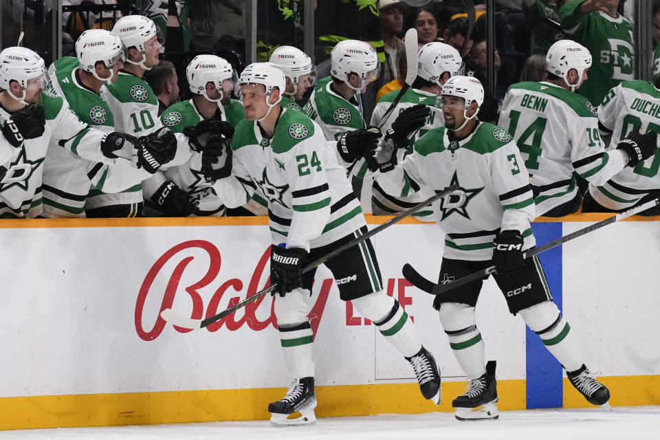 Dallas Stars center Roope Hintz (24) celebrates his goal with teammates during the second period of an NHL hockey game against the Nashville Predators, Thursday, Oct. 10, 2024, in Nashville, Tenn. (AP Photo/George Walker IV)