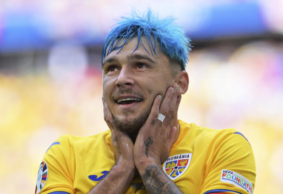 Romania's Andrei Ratiu smiles during a Group E match between Romania and Ukraine at the Euro 2024 soccer tournament in Munich, Germany, Monday, June 17, 2024. (Peter Kneffel/dpa via AP)