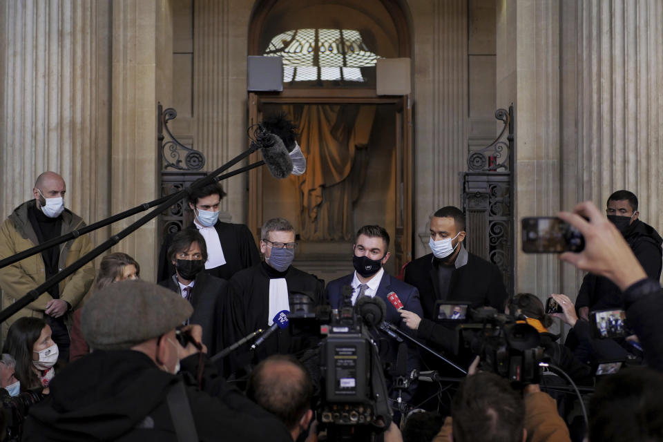 Alek Skarlatos, center right, Anthony Sadler, right, Mark Moogalian, left, and their lawyer Thibault de Montbrial, center left, deliver a speech during the Thalys attack trial at the Paris courthouse, Friday, Nov. 20, 2020. Passengers who wrestled and disarmed an Islamic State gunman aboard a high-speed Amsterdam to Paris train are recounting how their split-second decisions helped prevent what could have become a mass slaughter. AP Photo/Thibault Camus)