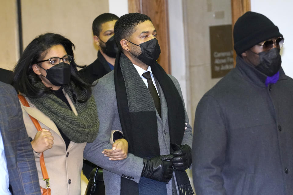 Actor Jussie Smollett, center, leaves the Leighton Criminal Courthouse, Thursday, Dec. 9, 2021, in Chicago, following a verdict in his trial. Smollett was convicted Thursday on five of six charges he staged an anti-gay, racist attack on himself nearly three years ago and then lied to Chicago police about it. (AP Photo/Charles Rex Arbogast)