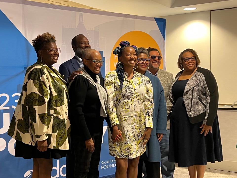 The Social Development Commission leadership team poses for a photo with Erika Alexander.