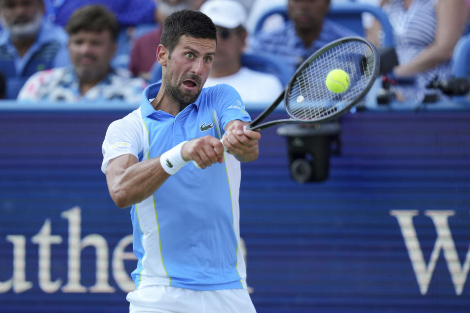 Novak Djokovic, of Serbia, returns a shot to Carlos Alcaraz, of Spain, during the men's singles final of the Western & Southern Open tennis tournament, Sunday, Aug. 20, 2023, in Mason, Ohio. (AP Photo/Aaron Doster)