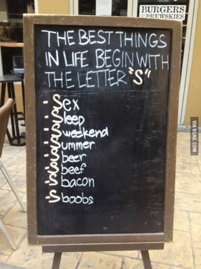 Signboard listing humorous items that begin with the letter 'S', such as sleep, beer, and bacons