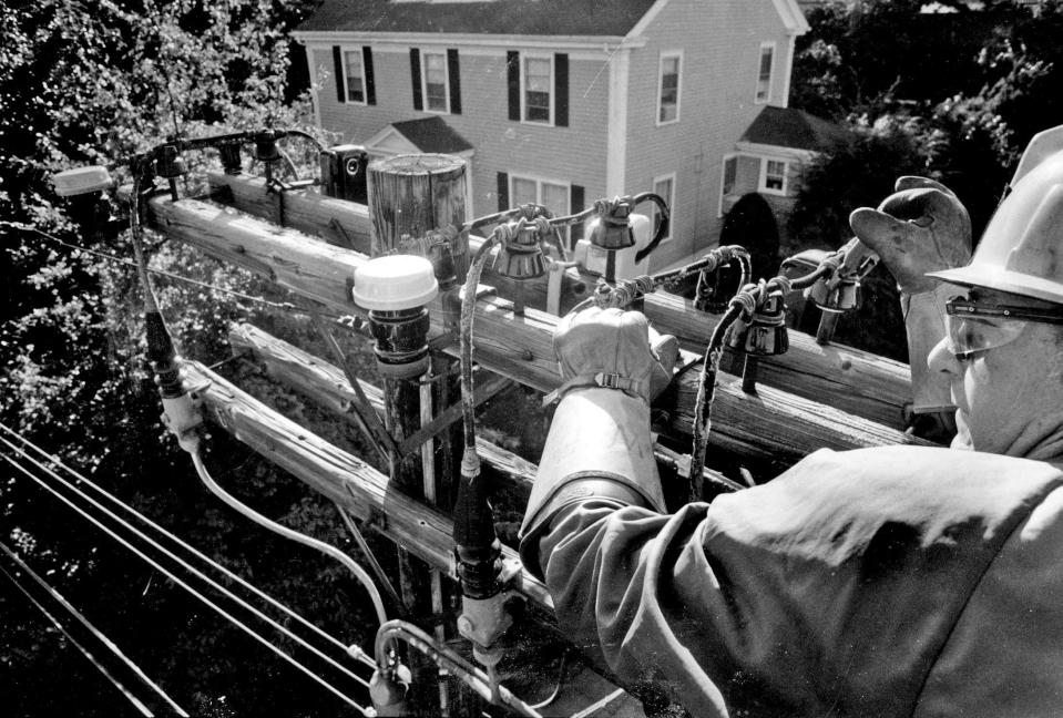 A lineman for Narragansett Electric repairs power lines feeding Providence's Elmgrove neighborhood in the days after Hurricane Gloria struck Rhode Island on Sept. 27, 1985.