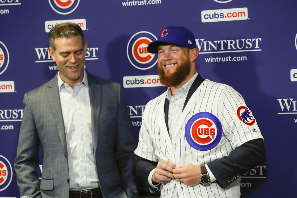 FILE - In this June 7, 2019, file photo, Chicago Cubs President Theo Epstein, left, introduces pitcher Craig Kimbrel during a news conference at Wrigley Field in Chicago. New Cubs closer Craig Kimbrel is at Triple-A Iowa, preparing to join the Cubs as they shoot for the N.L. Central crown.(Jose M. Osorio/Chicago Tribune via AP, File)