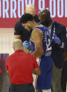 Philadelphia 76ers forward Tobias Harris (12) is attended to after hitting his head against the Boston Celtics during the third quarter of Game 4 of an NBA basketball first-round playoff series, Sunday, Aug. 23, 2020, in Lake Buena Vista, Fla. (Kim Klement/Pool Photo via AP)