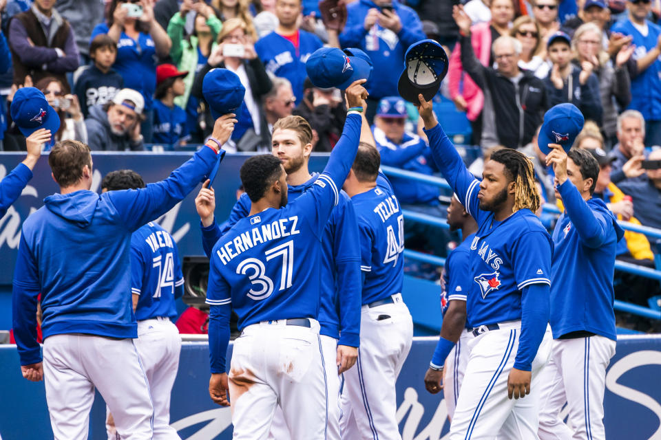 TORONTO, ONTARIO - SEPTEMBER 29: Vladimir Guerrero Jr. #27 of the Toronto Blue Jays and teammates salute the crowd during the last game of the season against the Tampa Bay Rays in the third inning during their MLB game at the Rogers Centre on September 29, 2019 in Toronto, Canada. (Photo by Mark Blinch/Getty Images)