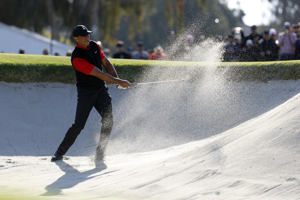 Tiger Woods hits from a bunker to the third green during the final round of the Genesis Invitational golf tournament at Riviera Country Club, Sunday, Feb. 19, 2023, in the Pacific Palisades area of Los Angeles. (AP Photo/Ryan Kang)