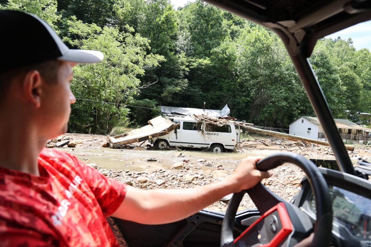 Louis Turner carries water to friends, family and neighbors along flood-ravaged Bowling Creek in Kentucky.