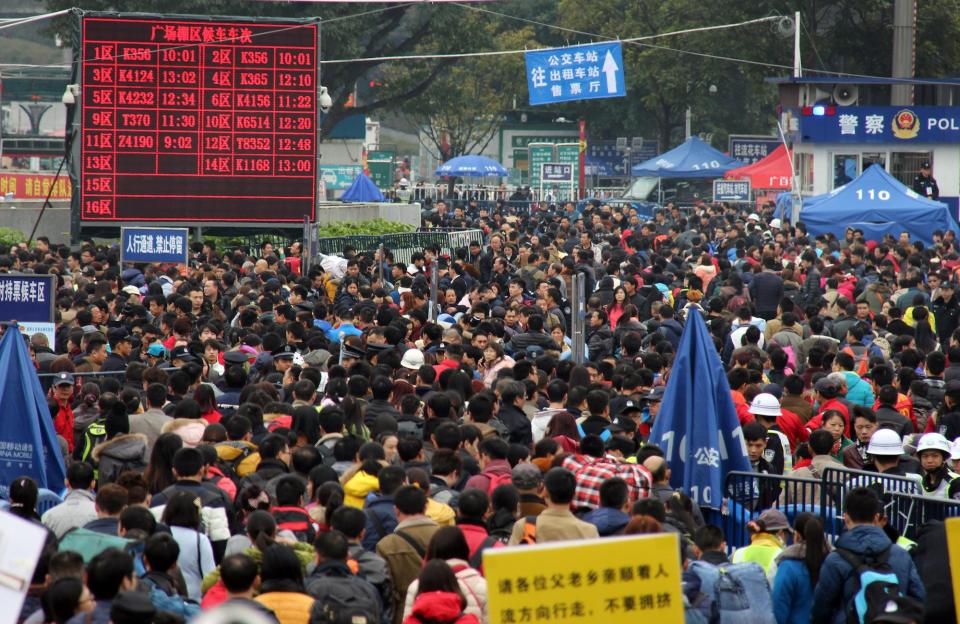 Travellers crowd the area outside one of the main train stations in Guangzhou as they arrive for their trains to head home for the upcoming Lunar New Year in southern China's Guangdong province on February 3, 2016.