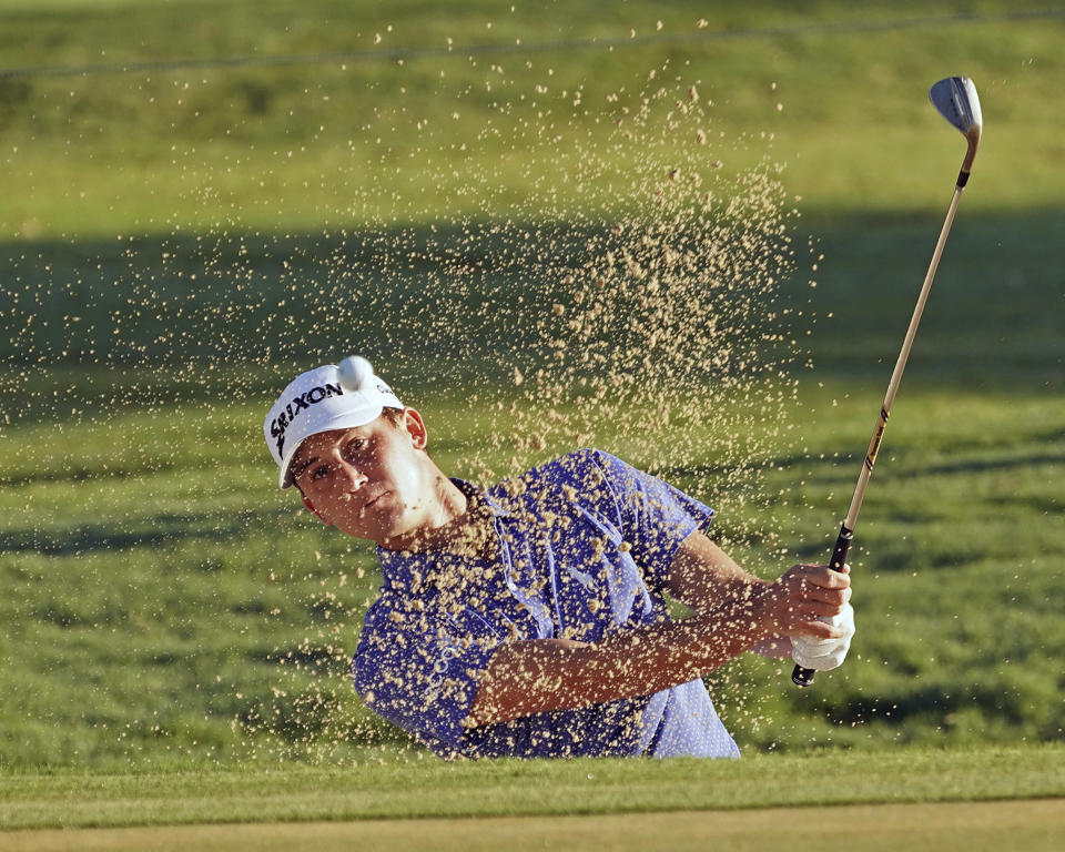 FILE - Smylie Kaufman hits out of a green side bunker on the 13th hole during the second round of the Sony Open golf tournament, Friday, Jan. 12, 2018, in Honolulu. NBC says Kaufman's "Happy Hour" set for its TV coverage will be part of the U.S. Open coverage this year. (AP Photo/Marco Garcia, File)