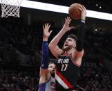 FILE - In this March 23, 2019, file photo, Portland Trail Blazers center Jusuf Nurkic, right, shoots as Detroit Pistons forward Blake Griffin defends during the second half of an NBA basketball game in Portland, Ore. Jusuf Nurkic is back and healthy. So are Zach Collins, Meyers Leonard, Giannis Antetokounmpo, Anthony Davis and plenty of others. If the four-month NBA shutdown had a silver lining, it’s that a lot of ailing players got well. (AP Photo/Steve Dipaola, File)