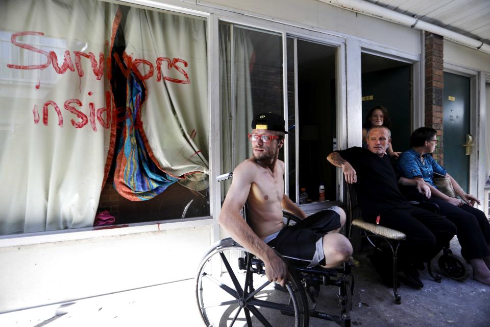 Wes Allen Jr., from left, sits with his father Wes Allen Sr., sister Alison, and mother Vicki outside their room at a damaged motel in Panama City, where many residents continue to live in the aftermath of Hurricane Michael. Many rode out the storm and have no place to go, even though many of the motel's rooms are uninhabitable.