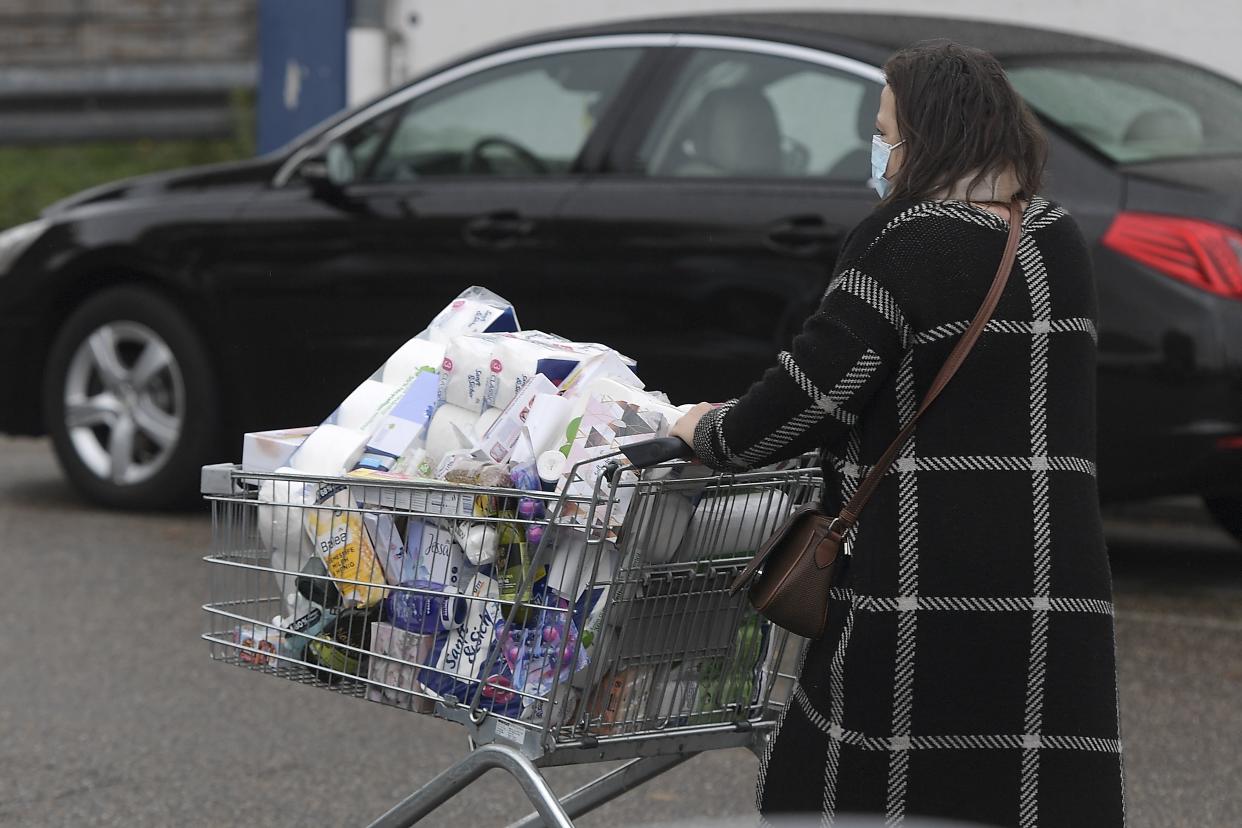 A woman pushes her shopping trolley in front of a supermarket in Kehl, on October 15, 2020, at the German-French border before any crossing restrictions are imposed. (Photo by FREDERICK FLORIN / AFP) (Photo by FREDERICK FLORIN/AFP via Getty Images)