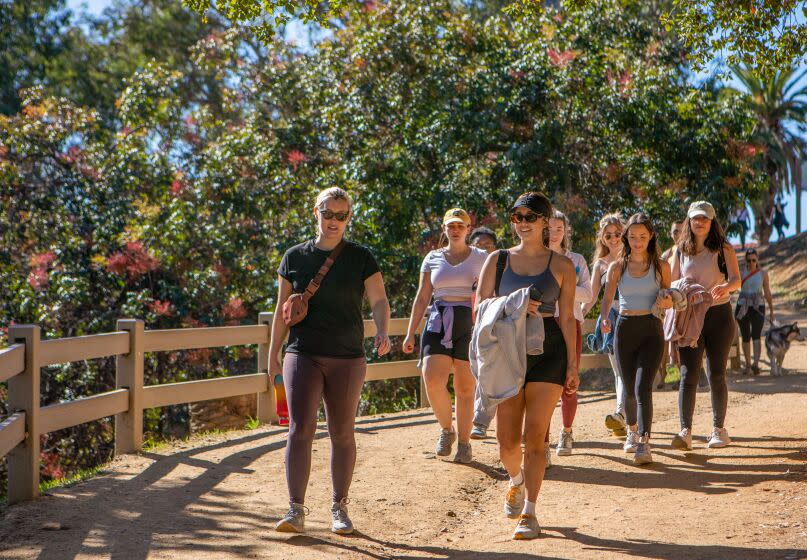 Los Angeles, CA - Monica Figueroa, middle, walks with a group of young women at Runyon Canyon Park on Saturday, Nov. 12, 2022, in Los Angeles, CA. Figueroa helps organize LA Girls Who Walk, which is a new group that organizes walking events for women for the sole purpose of making new friends. The group started in San Diego and later expanded to L.A., but has grown so popular that people have started spinoffs in their own neighborhoods using a Discord chat community. (Francine Orr / Los Angeles Times)