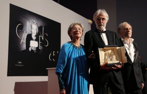 Austrian director Michael Haneke (C), with French actors Emmanuelle Riva (L) and Jean-Louis Trintignant, after being awarded with the Palme d'Or prize for his film Love" at the 65th Cannes film festival on May 27. "Love" is the wrenching tale of a man and his dying wife