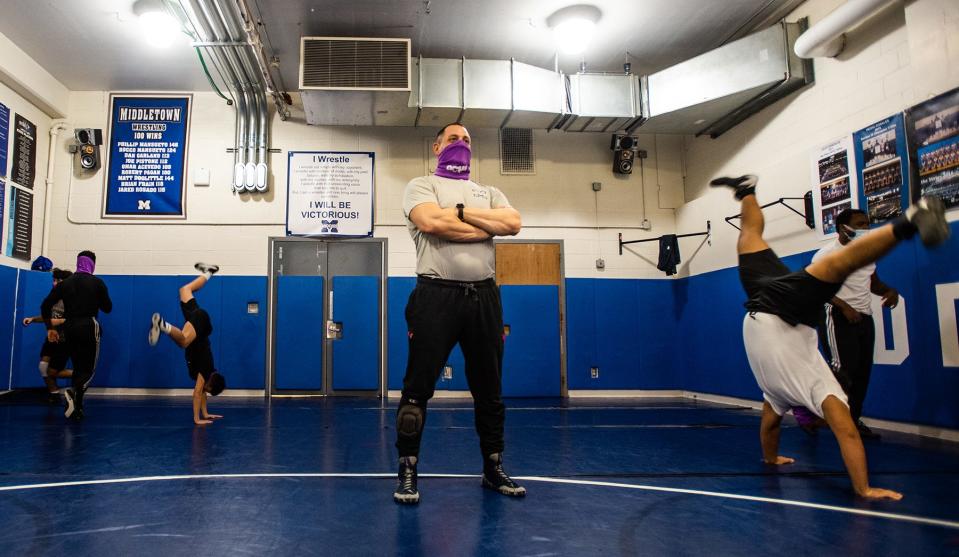 Middletown head wrestling coach Jason Lichtenstein runs a warm up drill  during practice at Middletown High School in Middletown, NY on Monday, January 24, 2022. Coach Lichtenstein has reached 200 career wins as coach.