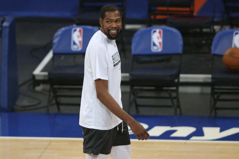 Brooklyn Nets forward Kevin Durant smiles as players warm up for the team's NBA basketball game against the New York Knicks on Wednesday, Jan. 13, 2021, in New York. (Brad Penner/Pool Photo via AP)