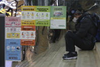 Posters on precautions against the coronavirus are displayed at a subway station in Seoul, South Korea, Tuesday, Nov. 24, 2020. The signs on posters read "Precautions against the coronavirus and please wear a mask." (AP Photo/Ahn Young-joon)