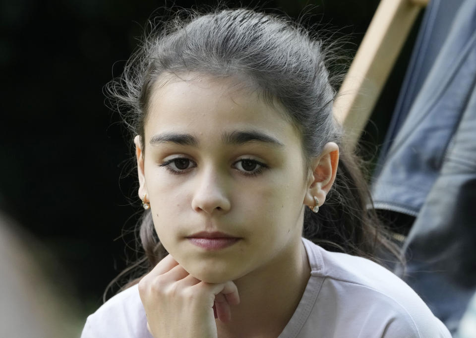 Milana Minenko, a 9-year-old child from Ukraine, glances to the side during an interview with The Associated Press, in Warsaw, Poland, Wednesday June 7, 2023. Russian forces have destroyed 262 educational institutions and damaged another 3,019 in their invasion of Ukraine, according to government figures. For those who've fled to other countries, schooling is suffering in unprecedented ways, according to families, educators, experts and advocates. The effects of war and relocation combined with the challenges of studying in a new country are compounding educational setbacks for young refugees. (AP Photo/Czarek Sokolowski)