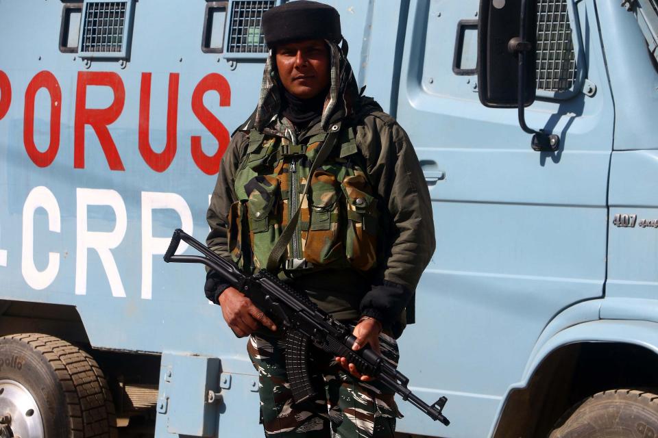 A Paramalitary soldier stands guard during a gunbattle between soldiers and suspected militants in Shopian.