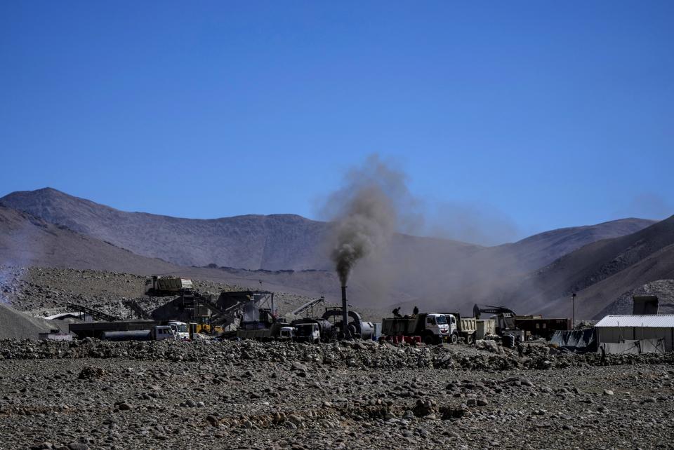 Black smoke rises from a chimney at a hot mix plant for blacktopping roads in the remote Kharnak village in the cold desert region of Ladakh, India, Sunday, Sept. 18, 2022. An increase in local pollution that has worsened due to the region’s militarization has exacerbated the melting of the glaciers in the region, experts say. (AP Photo/Mukhtar Khan)